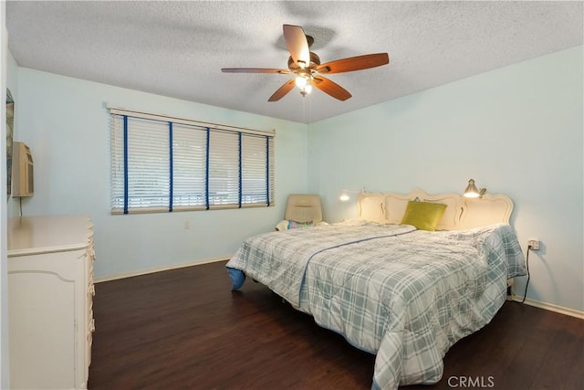 bedroom featuring ceiling fan, a textured ceiling, and dark hardwood / wood-style flooring