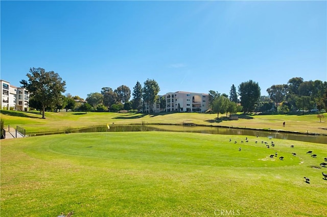 view of home's community with a yard and a water view