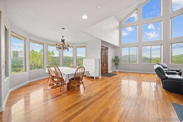 sunroom / solarium with an inviting chandelier