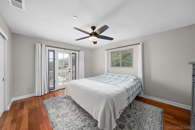 bedroom with dark wood-type flooring, ceiling fan, and access to exterior