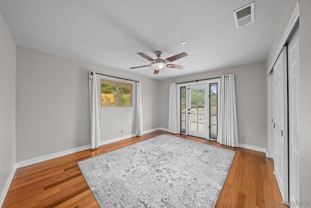 empty room featuring ceiling fan and light hardwood / wood-style flooring