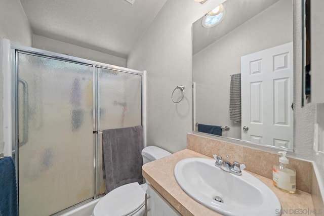 bathroom featuring lofted ceiling, vanity, toilet, and an enclosed shower