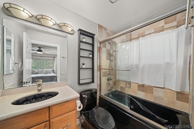 full bathroom featuring enclosed tub / shower combo, vanity, and toilet