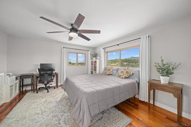 bedroom with hardwood / wood-style flooring and ceiling fan