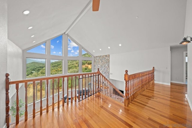 interior space with hardwood / wood-style floors, beam ceiling, high vaulted ceiling, and ceiling fan