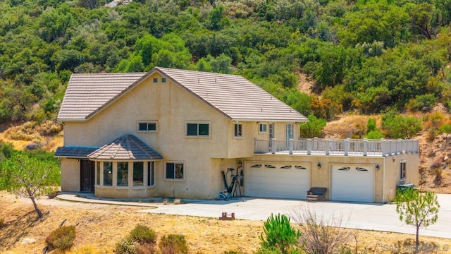 view of front facade featuring a garage and a balcony