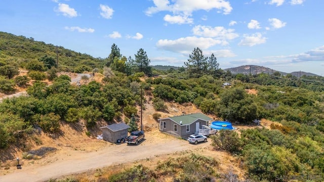 birds eye view of property with a mountain view