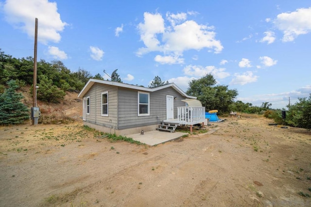 view of front of home with a deck and a patio area