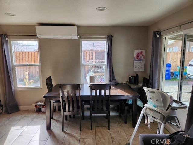 tiled dining room featuring a wall mounted AC