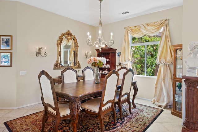 tiled dining room featuring an inviting chandelier