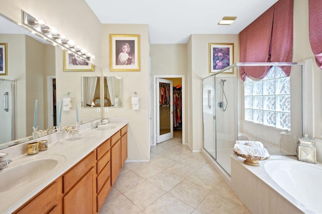 bathroom featuring tile patterned flooring, plus walk in shower, and vanity