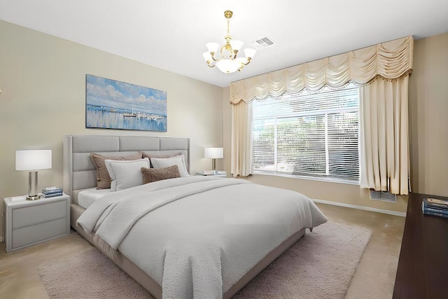 bedroom featuring light colored carpet and a chandelier