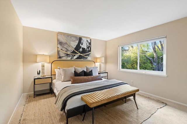 bedroom featuring light carpet