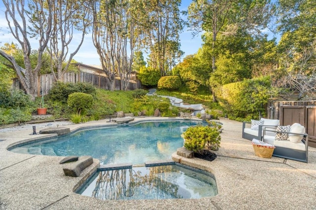 view of pool with an in ground hot tub and a patio