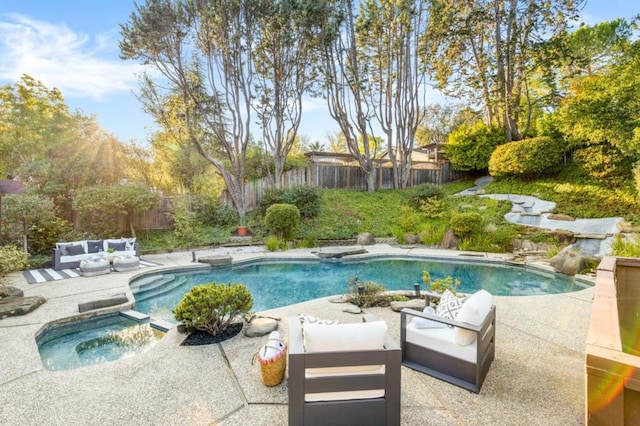 view of pool featuring a patio area and an in ground hot tub