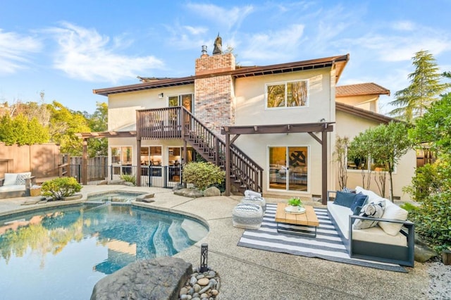 rear view of property featuring an outdoor living space, a pool with hot tub, and a patio