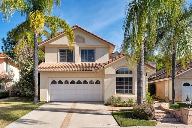 mediterranean / spanish-style home with a garage