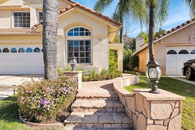 mediterranean / spanish home with a garage