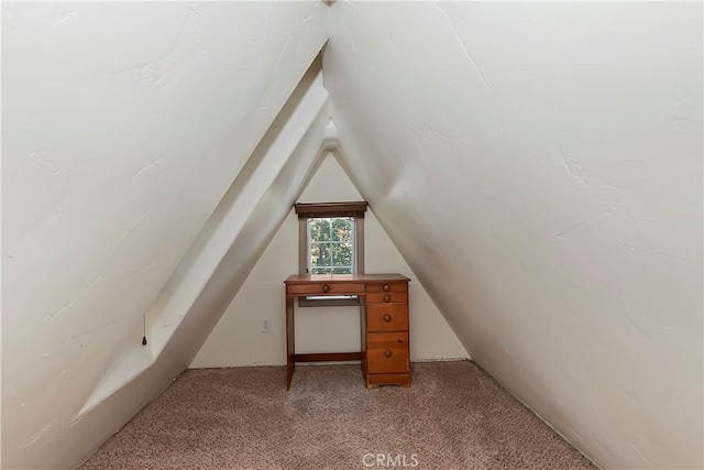 bonus room with vaulted ceiling and light carpet