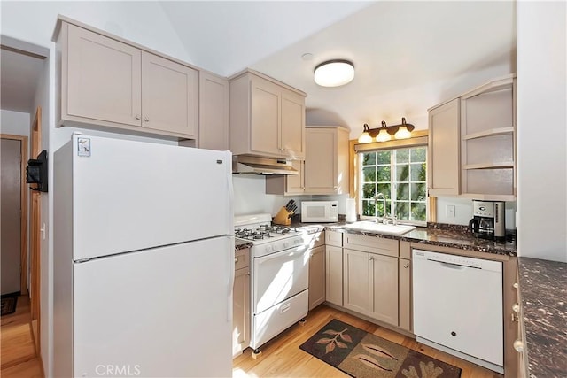 kitchen with sink, light hardwood / wood-style floors, white appliances, dark stone counters, and cream cabinets