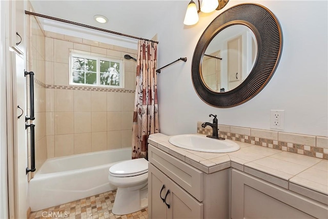 full bathroom featuring shower / bath combination with curtain, vanity, and toilet