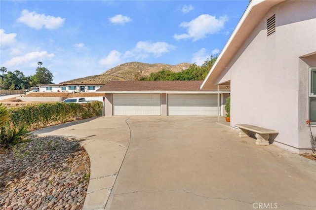 view of property exterior with a mountain view