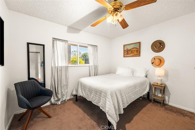 bedroom with ceiling fan, carpet flooring, and a textured ceiling