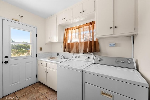 laundry area featuring cabinets, sink, light tile patterned floors, and washer and clothes dryer