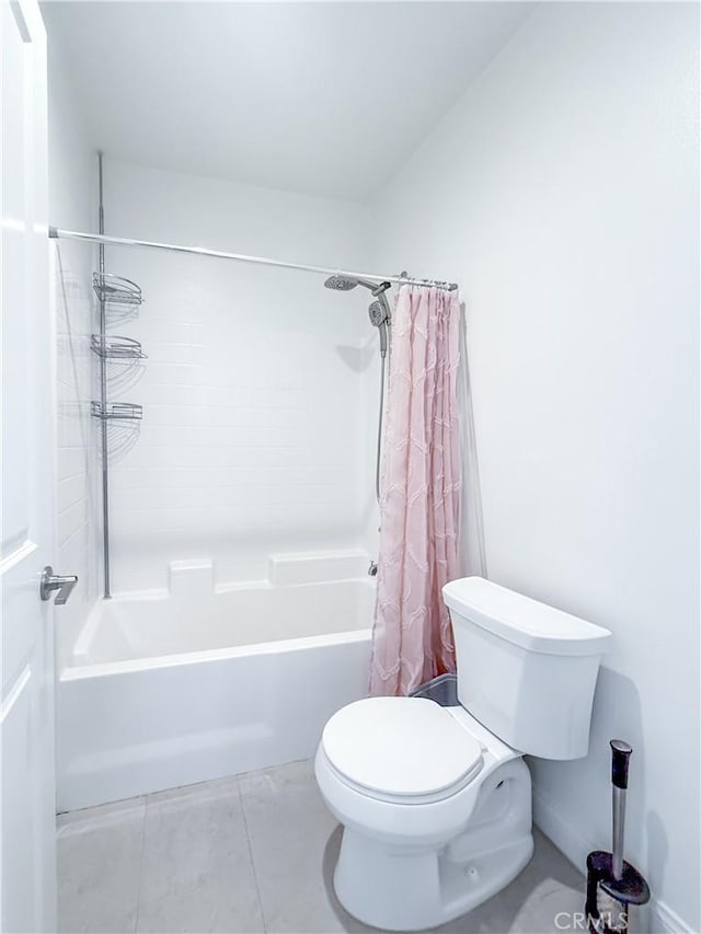 bathroom with shower / tub combo with curtain, tile patterned floors, and toilet