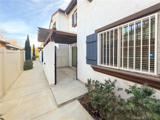 view of property exterior with a patio area