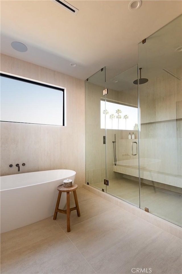 bathroom with tile patterned floors and separate shower and tub