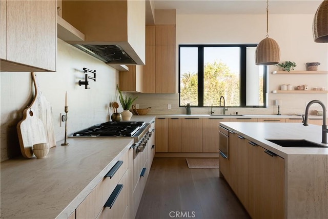 kitchen with pendant lighting, sink, dark hardwood / wood-style flooring, exhaust hood, and light brown cabinets