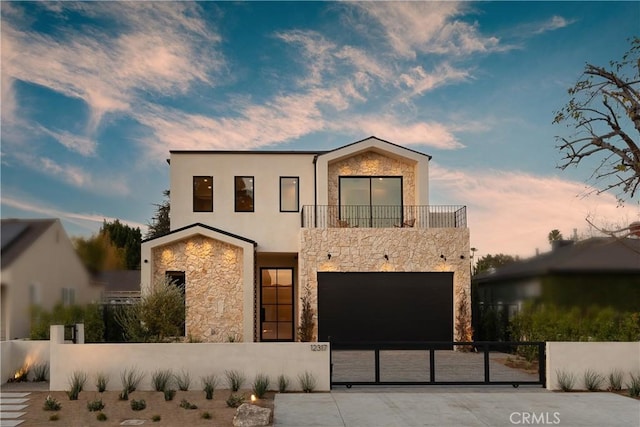 contemporary home featuring a garage and a balcony