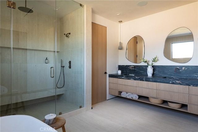 bathroom featuring vanity, tile patterned floors, and walk in shower