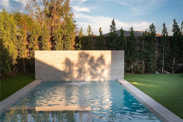 view of pool featuring a yard