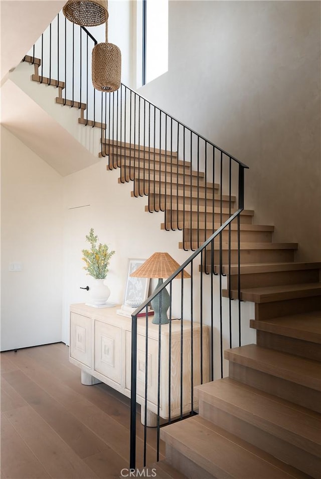 stairs with hardwood / wood-style floors