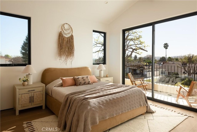 bedroom with access to outside and vaulted ceiling