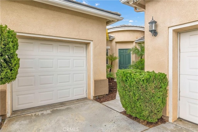 doorway to property with a garage