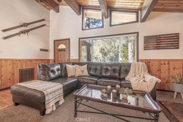 living room featuring wood walls, wood ceiling, high vaulted ceiling, beamed ceiling, and hardwood / wood-style floors