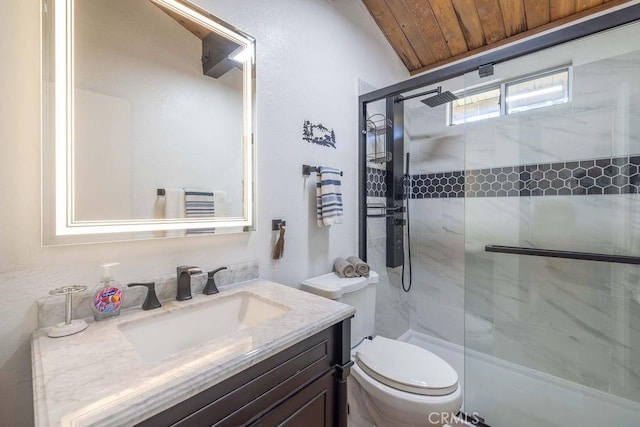 bathroom featuring vanity, toilet, and a shower with shower door