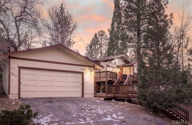 view of front of property with a wooden deck and a garage