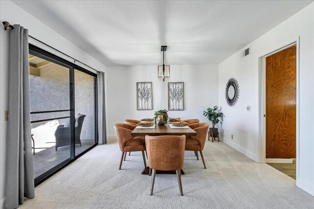 dining area with light colored carpet