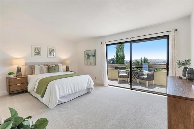 bedroom with access to outside and light colored carpet