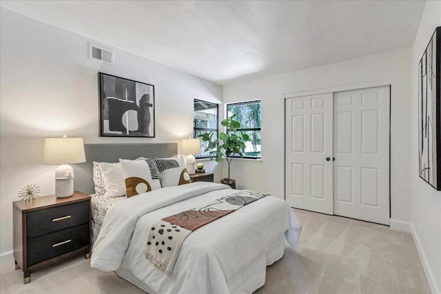 bedroom featuring light colored carpet and a closet