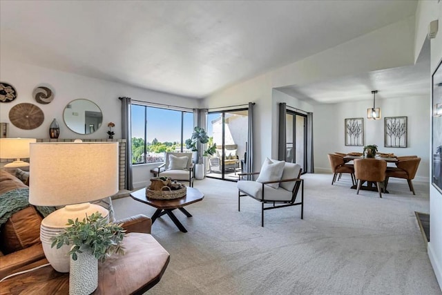 carpeted living room featuring vaulted ceiling