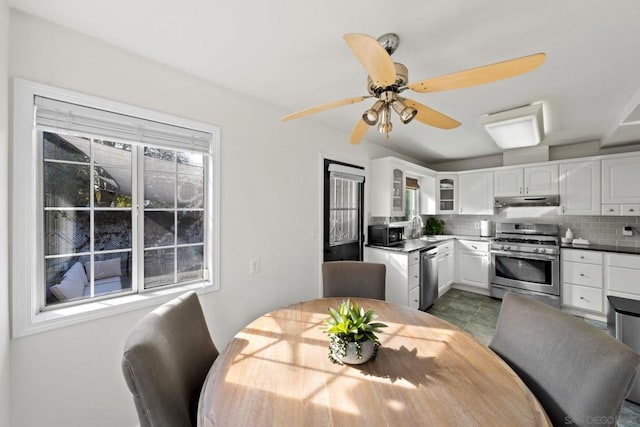 dining area with ceiling fan and sink