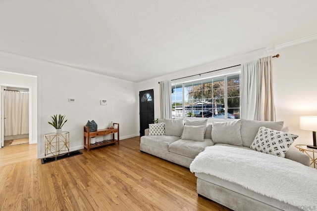 living room with hardwood / wood-style flooring and crown molding