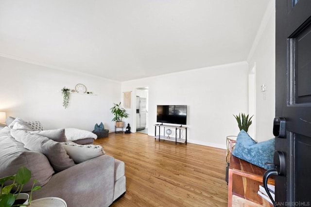 living room with ornamental molding and wood-type flooring