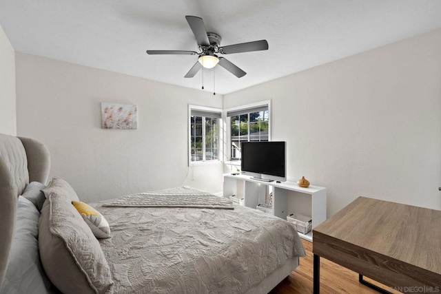 bedroom with hardwood / wood-style flooring and ceiling fan