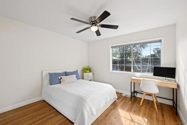 bedroom with hardwood / wood-style floors and ceiling fan